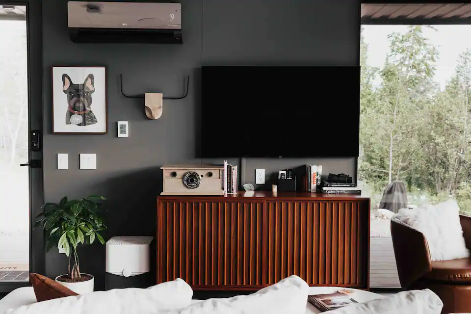 Mid-century medium console in walnut in a living room with art on the walls