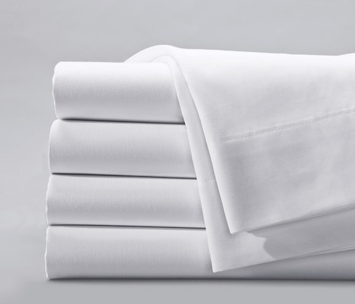 Best sheets for Airbnb - Centima by Standard Textile on a neatly made bed, showcasing their durability and guest comfortt