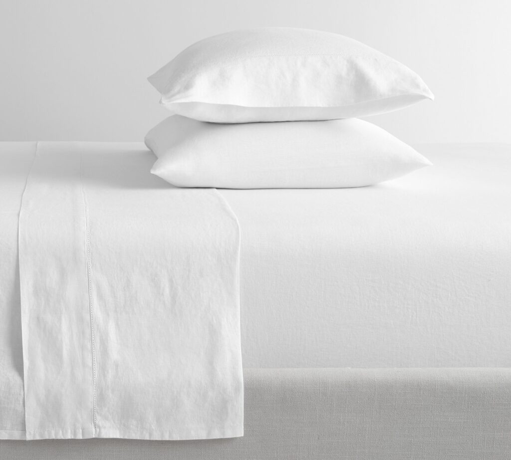 Best linen sheets - Pottery Barn Belgian Flax Linen, offering a cool and textured feel for vacation rentals.t